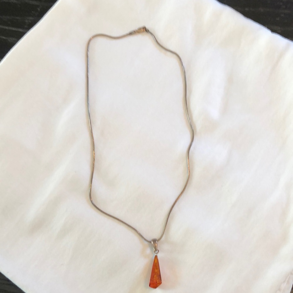 Sterling silver necklace with an amber pendant.